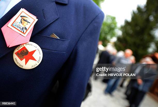 Supporter of former Yugoslav leader Josip Broz Tito with his insignias on his suite stands still as he pays tribute to the strongman on the 30th...