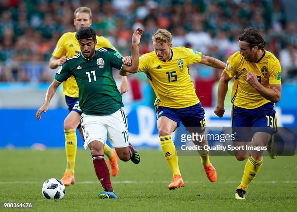 Carlos Vela of Mexico is challenged by Oscar Hiljemark of Sweden during the 2018 FIFA World Cup Russia group F match between Mexico and Sweden at...