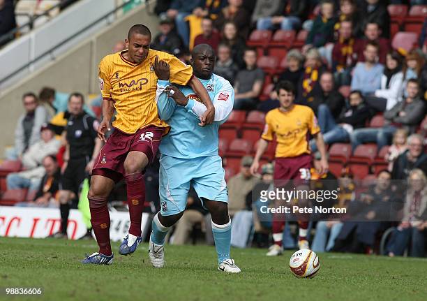Steve Williams of Bradford City contests the ball with Adebayo Akinfenwa of Northampton Town during the Coca Cola League Two Match between Bradford...