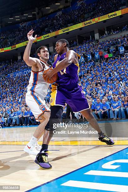 Andrew Bynum of the Los Angeles Lakers spins around Nenad Krstic of the Oklahoma City Thunder in Game Six of the Western Conference Quarterfinals...