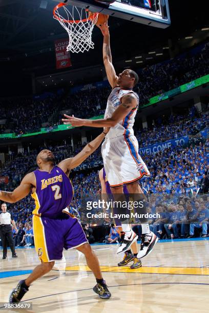 Thabo Sefolosha of the Oklahoma City Thunder goes to the basket over Derek Fisher of the Los Angeles Lakers in Game Six of the Western Conference...