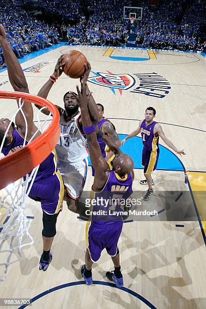 James Harden of the Oklahoma City Thunder goes to the basket against Andrew Bynum and Lamar Odom of the Los Angeles Lakers in Game Six of the Western...
