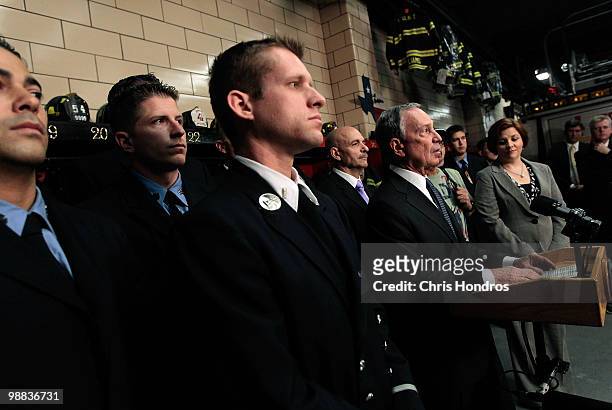 Firefighters from New York's Engine Co. 54, Ladder Co. 4 and Battalion 9 stand behind New York City Mayor Michael Bloomberg during a press conference...