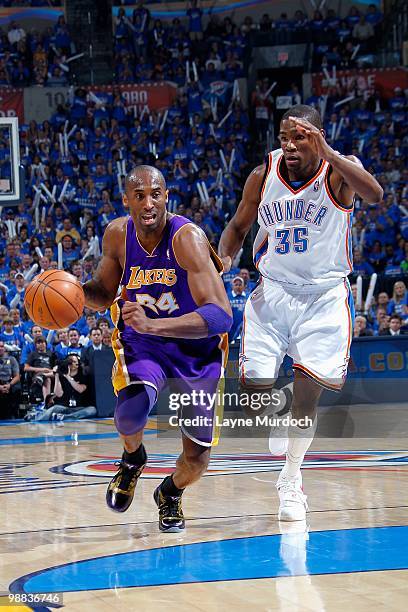 Kobe Bryant of the Los Angeles Lakers drives the ball up court followed by Kevin Durant of the Oklahoma City Thunder in Game Six of the Western...