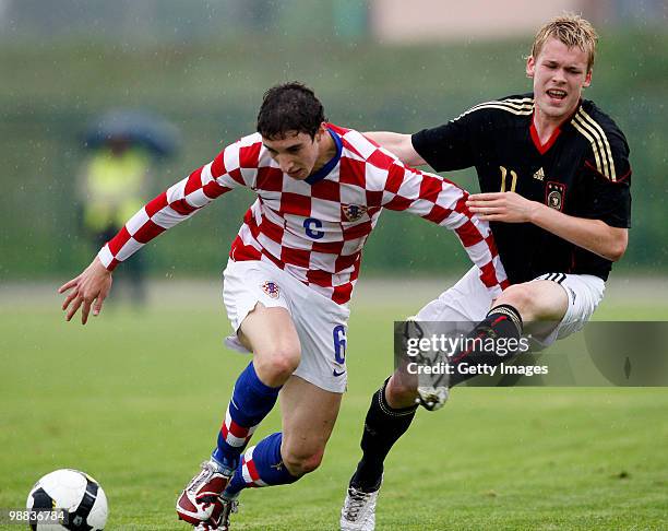 Sime Vrasljko of Croatia battles for the ball with Christopher Buchtmann of Germany during the U18 international friendly match between Croatia and...