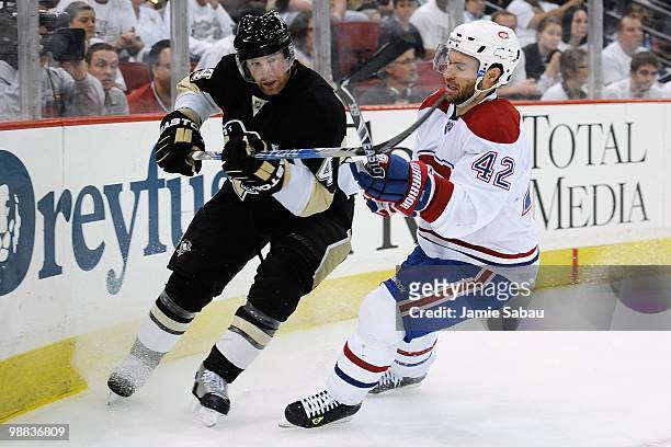 Jordan Leopold of the Pittsburgh Penguins clears the puck as Dominic Moore of the Montreal Canadiens defends in Game Two of the Eastern Conference...