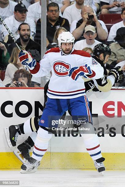 Roman Hamrlik of the Montreal Canadiens finishes a check against the Pittsburgh Penguins in Game Two of the Eastern Conference Semifinals during the...