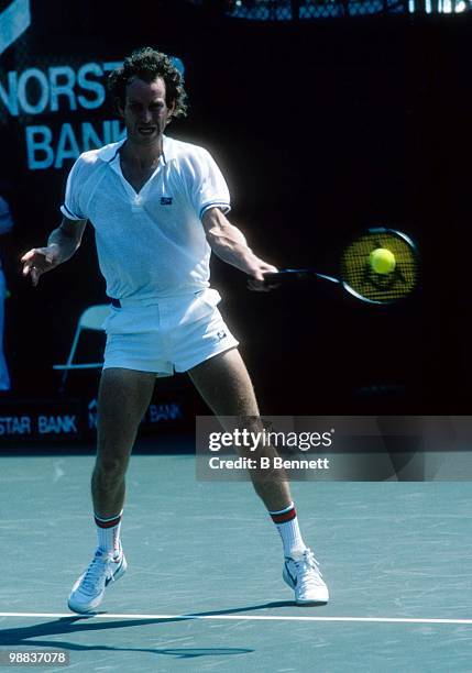 John McEnroe of the United States returns a ball during match play in the Hamlet Challenge Cup circa August 1986 in Long Island, New York.