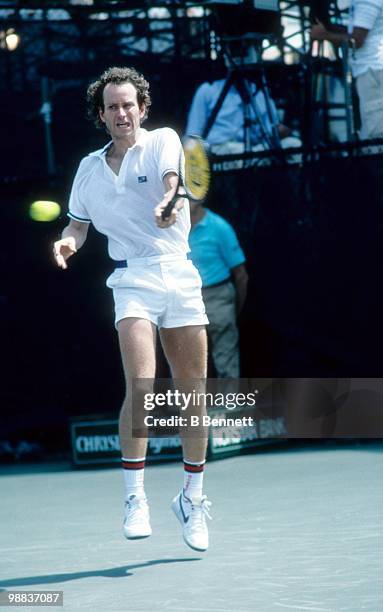 John McEnroe of the United States returns a ball during match play in the Hamlet Challenge Cup circa August 1986 in Long Island, New York.