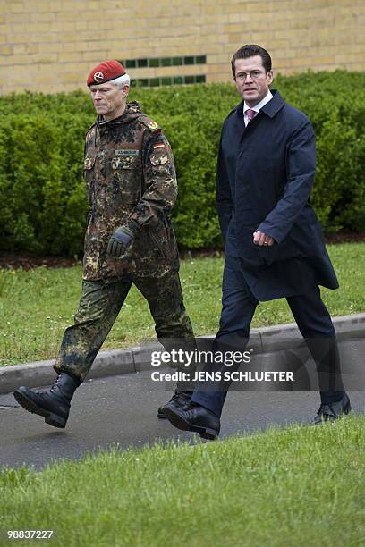 Major general Reinhard Kammer and German Defence Minister Karl-Theodor zu Guttenberg walk across the terrain of the General-Olbricht barracks after...