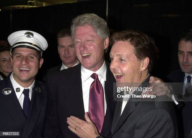 Bill Clinton and Paul McCartney backstage with police officers and fire fighters