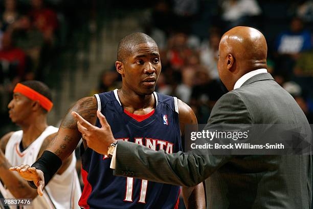 Jamal Crawford of the Atlanta Hawks talks with his head coach Mike Woodson during the game against the Charlotte Bobcats on April 6, 2010 at the Time...