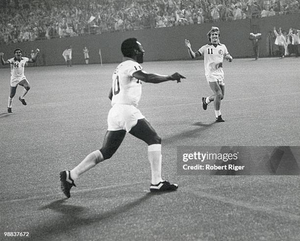 Pele of New York Cosmos and teammates Nelsi Morais and Stephen Hunt celebrate after Pele scored a goal against the Rochester Lancers during the...