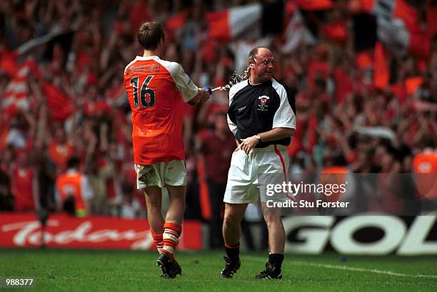 Manager Steve McMahon of Blackpool is spreyed by Brett Ormerod as Blackpool celebrates gaining promotion to the second division after the match...