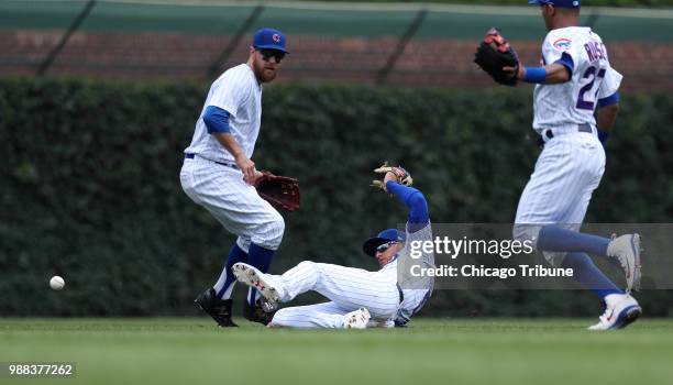 Chicago Cubs center fielder Albert Almora Jr. Slides after attempting to catch a pop up by the Minnesota Twins' Jake Cave in the second inning at...