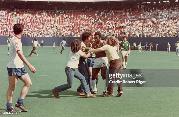 Pele of New York Cosmos is accosted by fans following a game at Giants Stadium in East Rutherford, New Jersey, circa 1975-77.