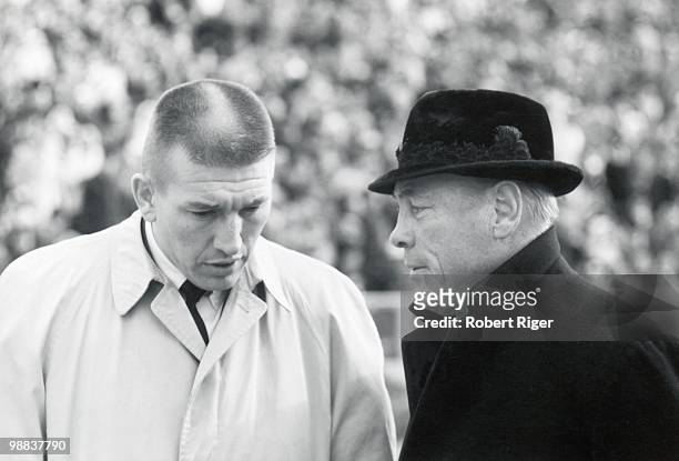 An injured Johnny Unitas of the Baltimore Colts speaks with team owner Carroll Rosenbloom during the 1965 Western Conference Playoff game against the...