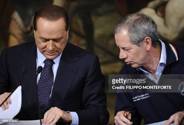 Italian Prime minister Silvio Berlusconi listens during a joint press conference with the head of the Italian Civil Protection Guido Bertolaso and...