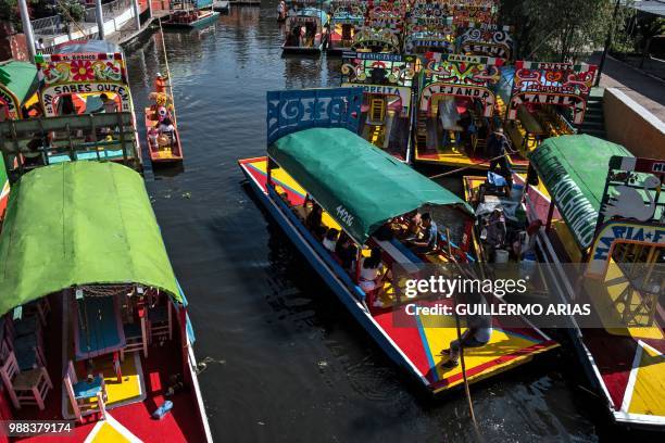 Visitors ride "trajineras" at Xochimilco borough in Mexico City June 30 a day before presidential election.
