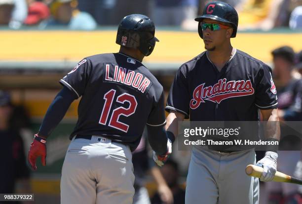 Francisco Lindor of the Cleveland Indians is congratulated by Michael Brantley after Lindor hit a solo home run against the Oakland Athletics in the...