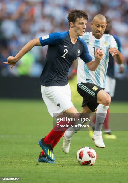 Benjamin Pavard of France vies Javier Mascherano of Argentina during the 2018 FIFA World Cup Russia Round of 16 match between France and Argentina at...