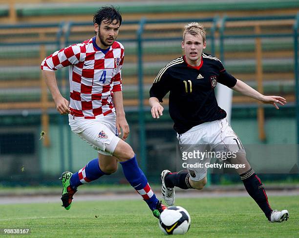 Miran Kraljevic of Croatia and Christopher Buchtmann of Germany battle for the ball during the U18 international friendly match between Croatia and...