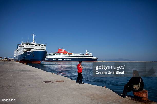 Men look on from the ferry dock on May 1, 2010 in Mytilene, Greece. Independent travel agency Sunvil has stated that Greek tourism will not be...