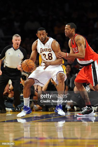 Didier Ilunga-Mbenga of the Los Angeles Lakers moves the ball against Marcus Camby of the Portland Trail Blazers during the game at Staples Center on...