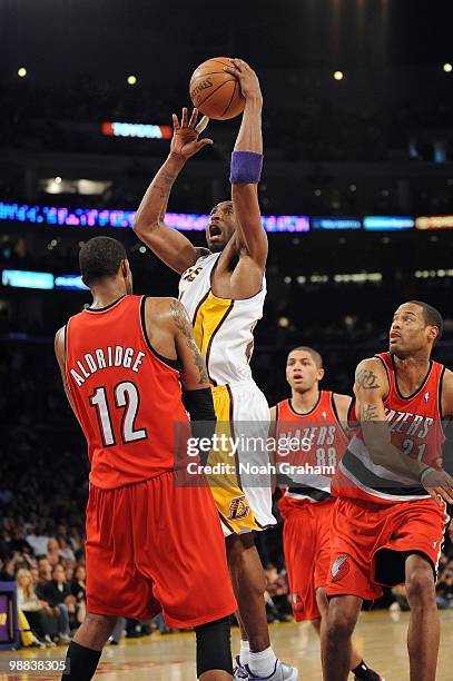 Kobe Bryant of the Los Angeles Lakers puts a shot up against LaMarcus Aldridge of the Portland Trail Blazers during the game at Staples Center on...