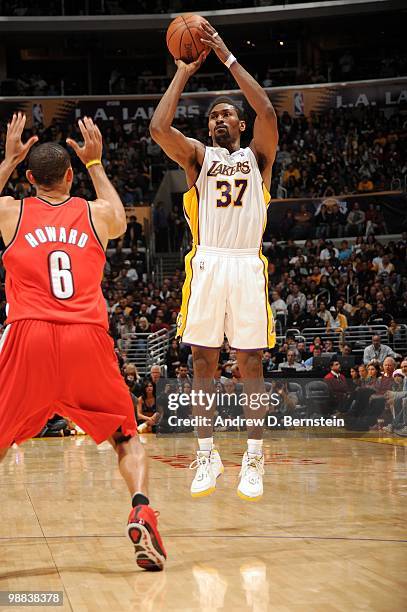 Ron Artest of the Los Angeles Lakers shoots against Juwan Howard of the Portland Trail Blazers during the game at Staples Center on April 11, 2010 in...