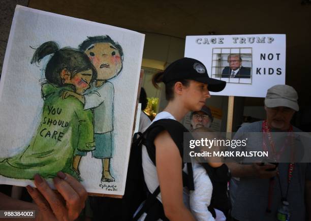 Demonstrators attend a march and rally June 30, 2018 outside the US Immigration and Customs Enforcement detention facility in Los Angeles, California...