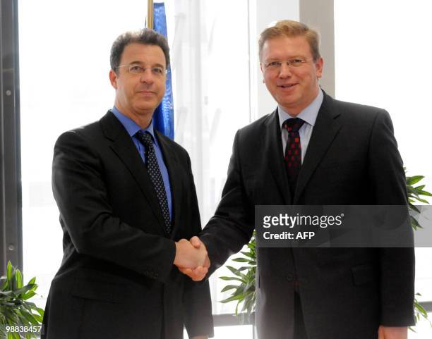 European Union Commissioner for Enlargement and European Neighbourhood Policy Stefan Fule shakes hands with Prosecutor of the International Criminal...
