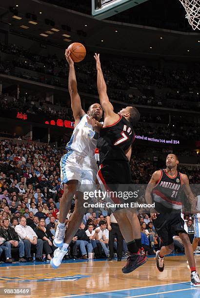 Malik Allen of the Denver Nuggets takes the ball to the basket against Brandon Roy of the Portland Trail Blazers during the game on April 1, 2010 at...