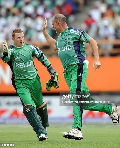 Ireland cricketers Niall O'Brien and Trent Johnston celebrates the wicket of England cricketer Paul Collingwood during their match in the ICC World...