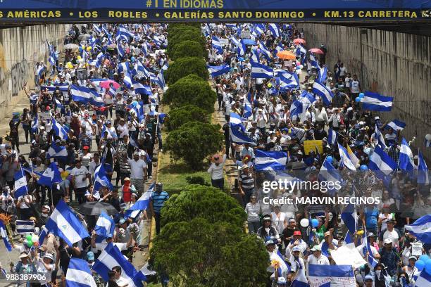 People attend the "Marcha de las Flores" -in honor of the children killed during protests- in Managua on June 30, 2018. - At least six people were...