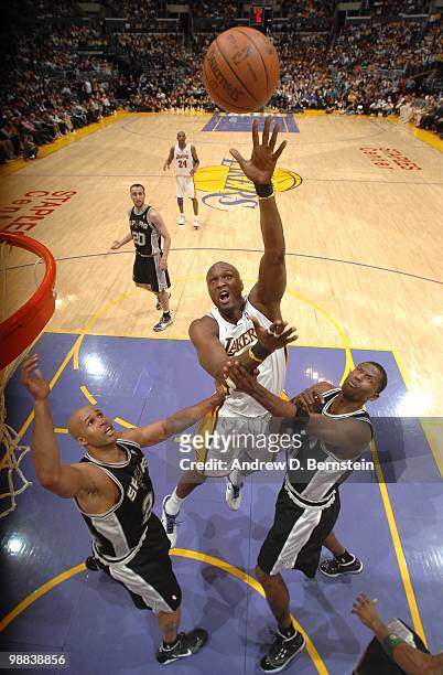 Lamar Odom of the Los Angeles Lakers shoots over Richard Jefferson and Antonio McDyess of the San Antonio Spurs during the game at Staples Center on...