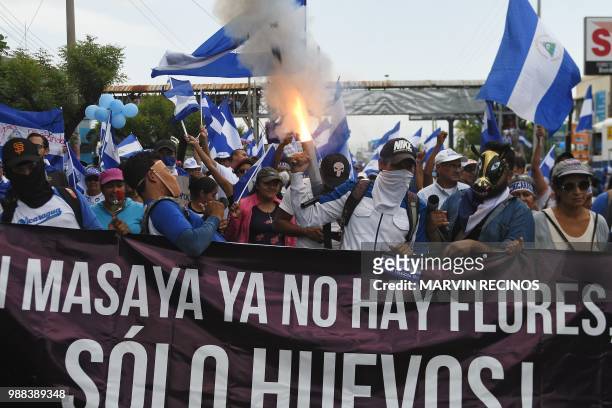 Man fires a homemade mortar during the "Marcha de las Flores" -in honor of the children killed during protests- in Managua on June 30, 2018. - At...