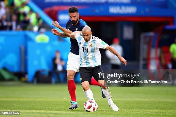 Javier Mascherano of Argentina is challenged by Olivier Giroud of France during the 2018 FIFA World Cup Russia Round of 16 match between France and...