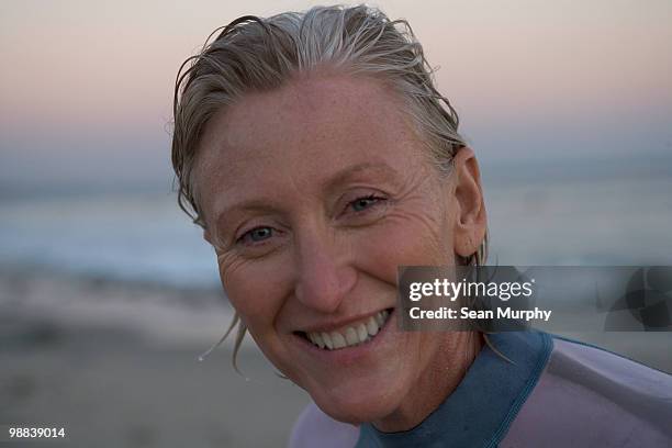 woman surfer at sunset - older woman wet hair stock pictures, royalty-free photos & images