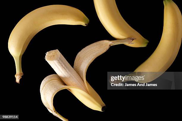 bananas with peeled banana - james hale stock pictures, royalty-free photos & images