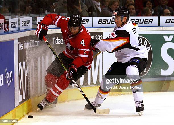 Christoph Ullmann of Germany challenges Brent Burns of Canada during the pre IIHF World Championship match between Germany and Canada at the O2 World...