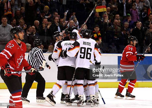 Sven Felski of Germany celebrates with his team mates after scoring his team's first goal during the pre IIHF World Championship match between...