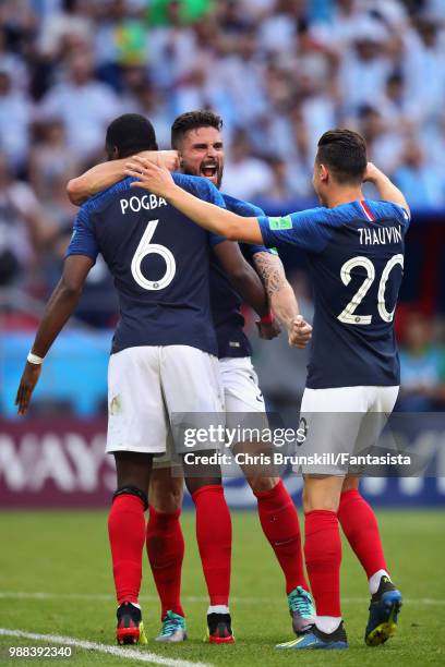 Paul Pogba, Florian Thauvin and Olivier Giroud all of France celebrate after the 2018 FIFA World Cup Russia Round of 16 match between France and...