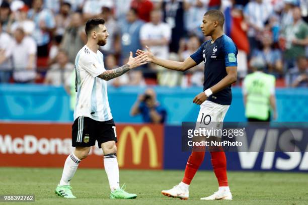 Lionel Messi of Argentina and Kylian Mbappe of France embrace after the 2018 FIFA World Cup Russia Round of 16 match between France and Argentina at...