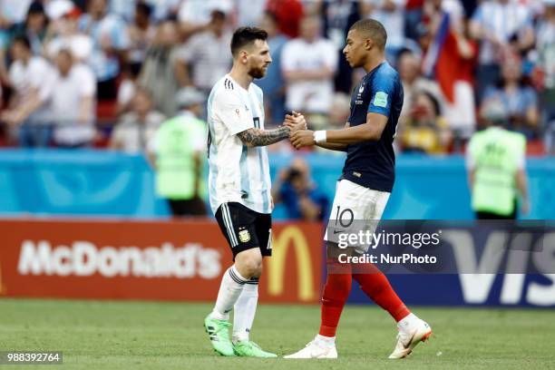 Lionel Messi of Argentina and Kylian Mbappe of France embrace after the 2018 FIFA World Cup Russia Round of 16 match between France and Argentina at...