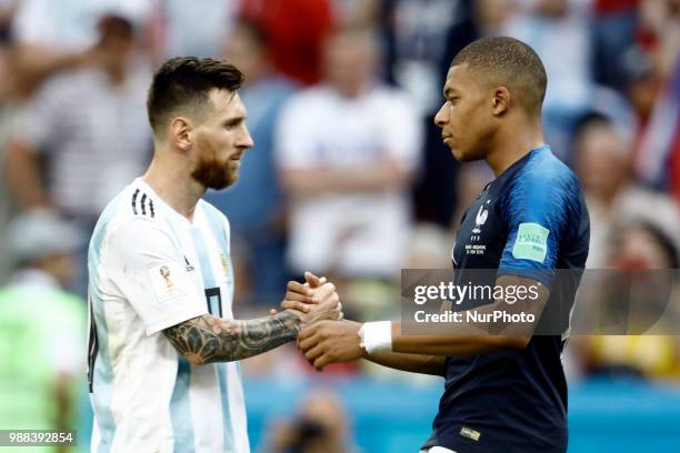 Lionel Messi of Argentina and Kylian Mbappe of France embrace after the 2018 FIFA World Cup Russia Round of 16 match between France and Argentina at...