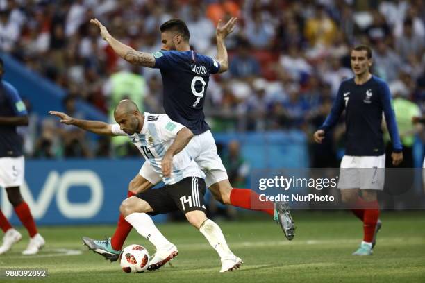 Javier Mascherano of Argentina vies Olivier Giroud of France team during the 2018 FIFA World Cup Russia Round of 16 match between France and...