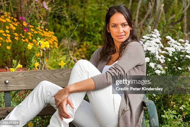 woman sitting on bench in garden - hungerford stock pictures, royalty-free photos & images