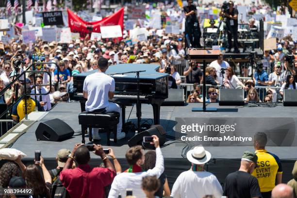 Musician John Legend performs onstage at 'Families Belong Together - Freedom for Immigrants March Los Angeles' at Los Angeles City Hall on June 30,...