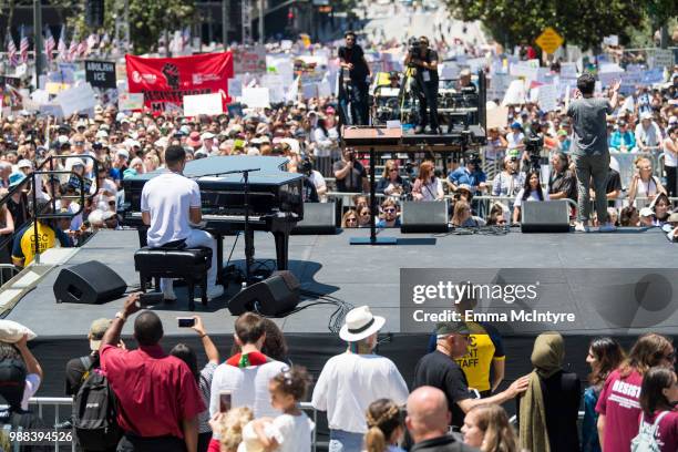 Musician John Legend performs onstage at 'Families Belong Together - Freedom for Immigrants March Los Angeles' at Los Angeles City Hall on June 30,...